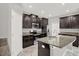 Modern kitchen featuring granite countertops, stainless steel appliances, and dark wood cabinetry at 7336 Bagley Cove Ct, Sun City Center, FL 33573