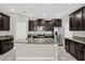 Stylish kitchen with granite island, stainless steel appliances, and sleek dark wood cabinets at 7336 Bagley Cove Ct, Sun City Center, FL 33573