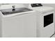 Laundry room featuring GE washer and dryer, offering convenience and efficiency at 7336 Bagley Cove Ct, Sun City Center, FL 33573