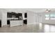 Bright open floor plan combining the kitchen and living area with tile floors and neutral paint at 7336 Bagley Cove Ct, Sun City Center, FL 33573