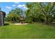 Lush backyard lawn with stone patio and seating area at 7775 Still Lakes Dr, Odessa, FL 33556