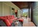 Large covered patio with plush seating and views of a beautiful, green backyard at 7775 Still Lakes Dr, Odessa, FL 33556