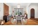 Formal dining room featuring elegant decor, hardwood flooring, and large windows at 7775 Still Lakes Dr, Odessa, FL 33556