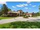 Impressive exterior showcases circular driveway, manicured lawn, and architectural charm at 7775 Still Lakes Dr, Odessa, FL 33556
