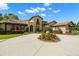 Beautiful home featuring a circular driveway with manicured landscaping and mature trees at 7775 Still Lakes Dr, Odessa, FL 33556
