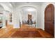 Inviting foyer leading into the dining room with arched doorways and unique floor design at 7775 Still Lakes Dr, Odessa, FL 33556
