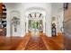 Elegant foyer with arched doorways, tile flooring, and views into the spacious living area, offering a grand entrance at 7775 Still Lakes Dr, Odessa, FL 33556