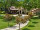 Inviting home with a circular driveway, manicured lawn, and mature trees, showcasing a serene landscape at 7775 Still Lakes Dr, Odessa, FL 33556