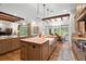 Gourmet kitchen with stainless steel appliances, large kitchen island and breakfast nook at 7775 Still Lakes Dr, Odessa, FL 33556