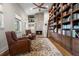 Cozy library with fireplace, custom built-ins, and comfortable seating at 7775 Still Lakes Dr, Odessa, FL 33556