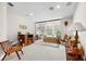 Spacious living room with a daybed by the windows, featuring natural light and cozy seating at 7775 Still Lakes Dr, Odessa, FL 33556