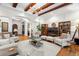 Spacious living room with beamed ceilings, neutral furniture, and open layout, creating an inviting atmosphere at 7775 Still Lakes Dr, Odessa, FL 33556