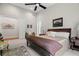 Bright main bedroom featuring large windows, ceiling fan, sitting area, and ensuite bathroom at 7775 Still Lakes Dr, Odessa, FL 33556