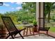 Outdoor seating area with lounge chairs and view of a well maintained lawn with mature trees at 7775 Still Lakes Dr, Odessa, FL 33556