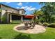 Outdoor patio with stone pavers, screened enclosure, mature landscaping, and outdoor seating at 7775 Still Lakes Dr, Odessa, FL 33556