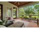 Inviting screened porch with lounge furniture and views of the lush backyard at 7775 Still Lakes Dr, Odessa, FL 33556