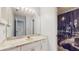 This is a cozy bathroom with white cabinets, light countertops, and shower with a cityscape-themed curtain at 7802 Hardwick Dr # 1126, New Port Richey, FL 34653
