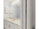 Bright bathroom featuring a vanity with ample storage, a large mirror, and neutral wall paint at 7802 Hardwick Dr # 1126, New Port Richey, FL 34653