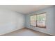 Light blue bedroom featuring carpet flooring and a window providing natural light at 7802 Hardwick Dr # 1126, New Port Richey, FL 34653