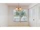 Dining area featuring a chandelier, large window, and closet storage at 7802 Hardwick Dr # 1126, New Port Richey, FL 34653