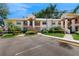 Inviting two-story condo with well-maintained landscaping, two palm trees, and clearly marked parking spots at 7802 Hardwick Dr # 1126, New Port Richey, FL 34653