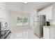 Eat-in kitchen with natural light, stainless steel refrigerator, and stylish granite countertops at 7802 Hardwick Dr # 1126, New Port Richey, FL 34653
