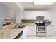 Updated kitchen boasts granite counters, stainless appliances, and white cabinetry at 7802 Hardwick Dr # 1126, New Port Richey, FL 34653