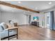 Spacious living room with hardwood floors, comfortable seating, and a modern television at 8258 Forest Cir, Seminole, FL 33776