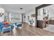 Bright living space featuring hardwood floors and an open view into the kitchen at 8258 Forest Cir, Seminole, FL 33776