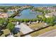 A high-angle view shows residences along a scenic waterway with boat docks and lush greenery at 8408 Flagstone Dr, Tampa, FL 33615