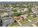 Aerial view of the property and neighborhood with mature trees and nearby homes at 8408 Flagstone Dr, Tampa, FL 33615