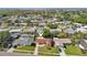 Aerial view of a residential neighborhood showcasing a well-located home with a landscaped yard near waterfront at 8408 Flagstone Dr, Tampa, FL 33615