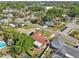 An aerial view of a residential neighborhood showcases well-maintained homes and mature trees at 8408 Flagstone Dr, Tampa, FL 33615