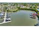 An aerial view features a marina with multiple boats docked in a calm waterway, surrounded by residences and foliage at 8408 Flagstone Dr, Tampa, FL 33615