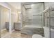 Bathroom showcasing a bathtub with glass doors and grey tile, vanity with cabinet, and a mirror at 8408 Flagstone Dr, Tampa, FL 33615