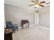 Bright bedroom with fan, large desk, and blue chair at 8408 Flagstone Dr, Tampa, FL 33615