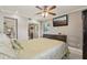 Cozy bedroom features a ceiling fan, television, and view of the closet with sliding doors at 8408 Flagstone Dr, Tampa, FL 33615