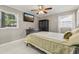 Cozy bedroom with two windows, a ceiling fan, and dark wooden furnishings at 8408 Flagstone Dr, Tampa, FL 33615