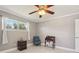 Bedroom features a ceiling fan, window, night stand and desk at 8408 Flagstone Dr, Tampa, FL 33615