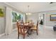 Bright dining room featuring marble floors, a chandelier, and a view of the beautifully landscaped backyard at 8408 Flagstone Dr, Tampa, FL 33615