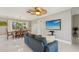 Elegant dining area with a wooden table set, bright natural light, new floors, and stylish light fixture at 8408 Flagstone Dr, Tampa, FL 33615