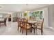 Dining area featuring a wooden table and chairs, view to living space, and marble floors at 8408 Flagstone Dr, Tampa, FL 33615