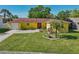 Charming single-story home with a well-maintained front yard and mature landscaping at 8408 Flagstone Dr, Tampa, FL 33615