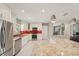 Bright, modern kitchen features white cabinets, stainless steel appliances, granite countertops, and a red backsplash at 8408 Flagstone Dr, Tampa, FL 33615