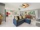 Bright open-concept living room with new marble floors, a comfortable couch, and a view of the dining area at 8408 Flagstone Dr, Tampa, FL 33615