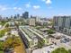 Wide aerial perspective of modern townhomes with city skyline and surrounding neighborhood at 907 Arlington N Ave, St Petersburg, FL 33705
