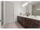 Modern bathroom features dual sinks, sleek wood cabinets, shower with glass enclosure, and neutral color palette at 907 Arlington N Ave, St Petersburg, FL 33705