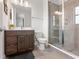 Chic bathroom boasts a glass-enclosed shower, modern fixtures, dark cabinets, and neutral finishes at 907 Arlington N Ave, St Petersburg, FL 33705