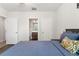 Comfortable bedroom with access to a bathroom, wood-look floors, and closet storage at 907 Arlington N Ave, St Petersburg, FL 33705