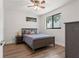 Comfortable bedroom featuring hardwood floors, ceiling fan, and a window with a pleasant outdoor view at 907 Arlington N Ave, St Petersburg, FL 33705